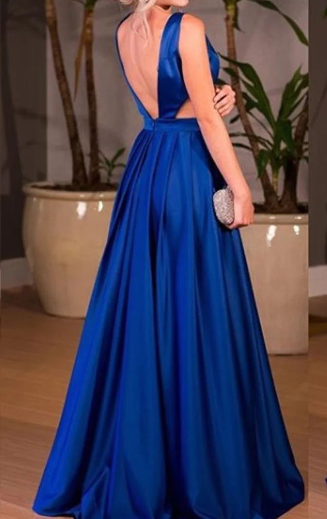 Full-length view of a woman in a flowy satin formal gown.