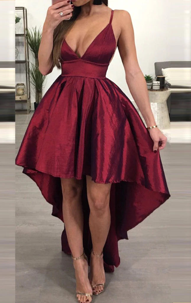 Woman wearing an elegant deep V-neck high-low prom dress with delicate straps.