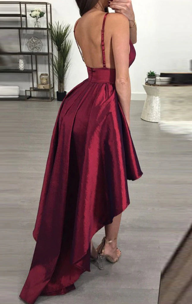 Back view of a woman in a high-low formal gown, showcasing the flowing hem.
