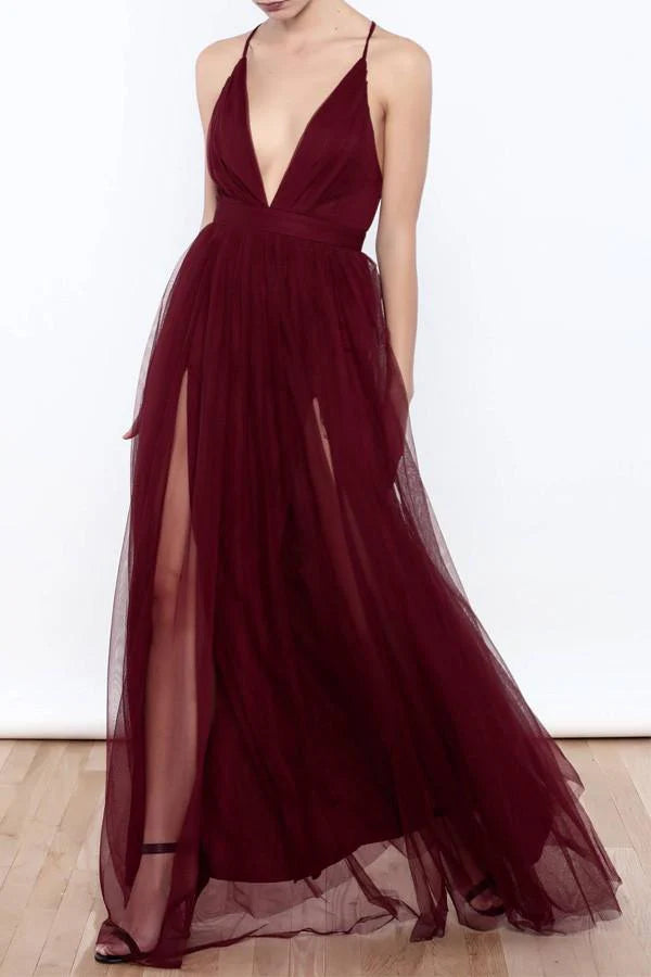 Woman wearing an elegant deep V neck tulle high slit prom dress.