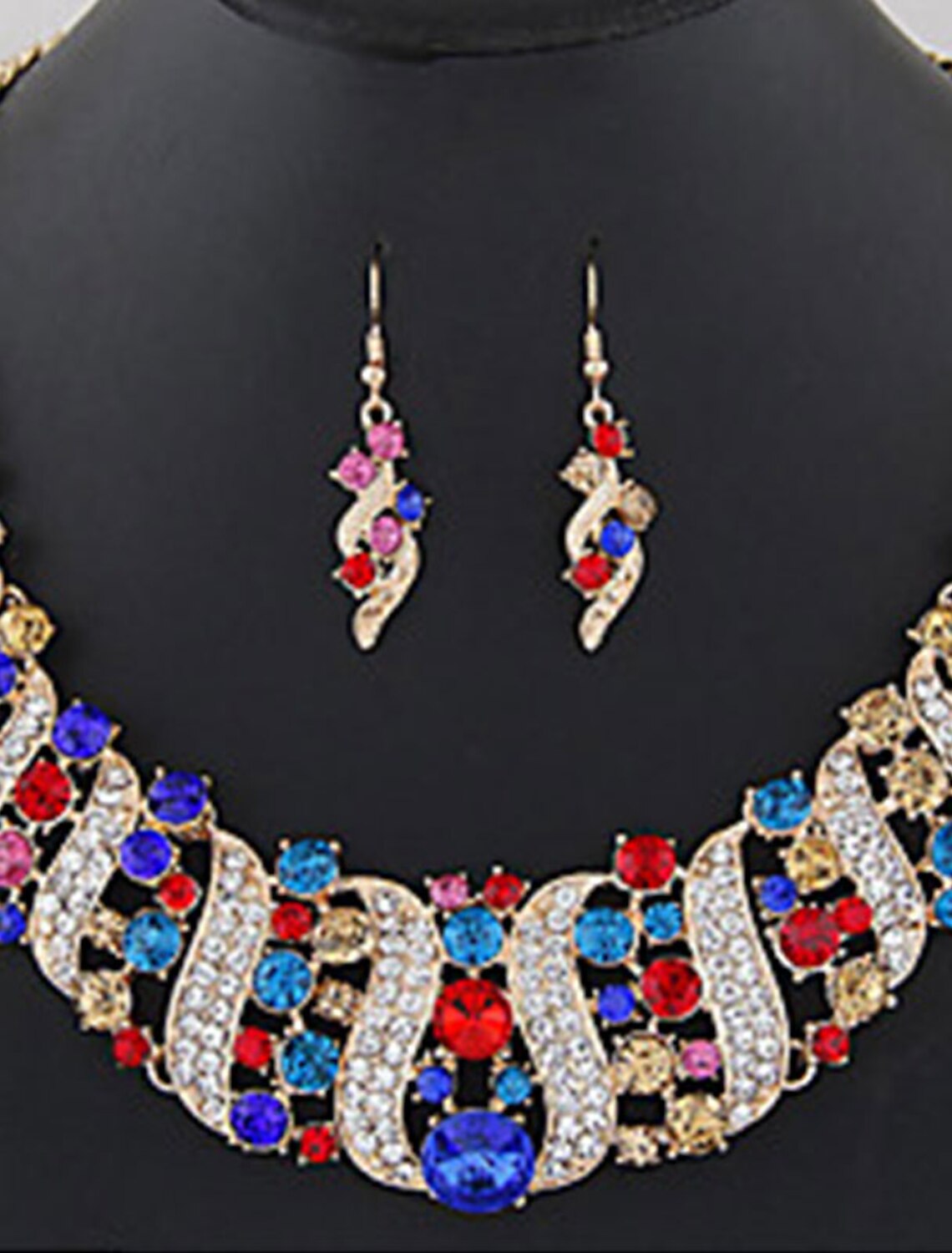 Close-up of matching diamond alloy earrings with a geometrical pattern.