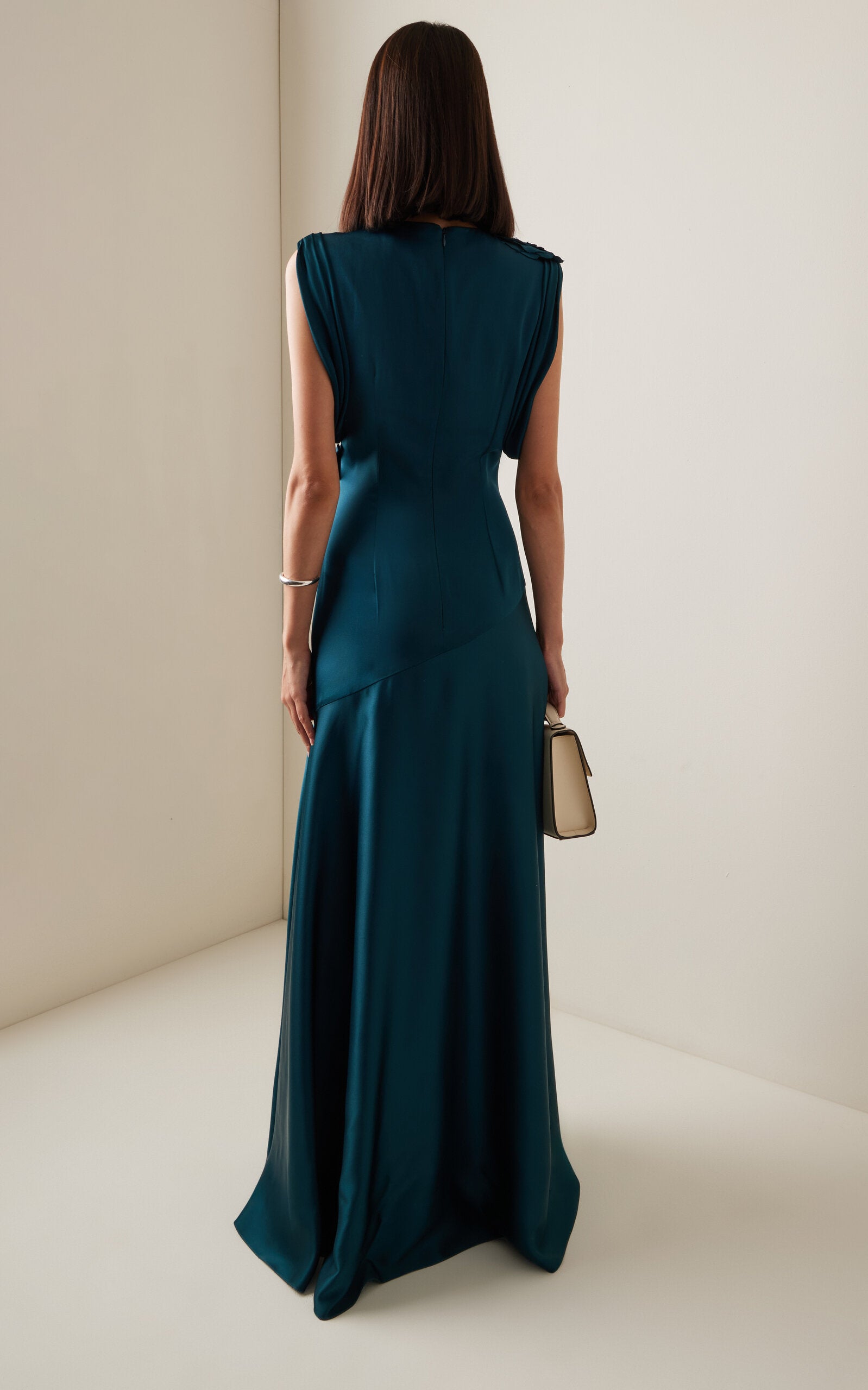 Back view of sleeveless satin prom gown with embellishments.
