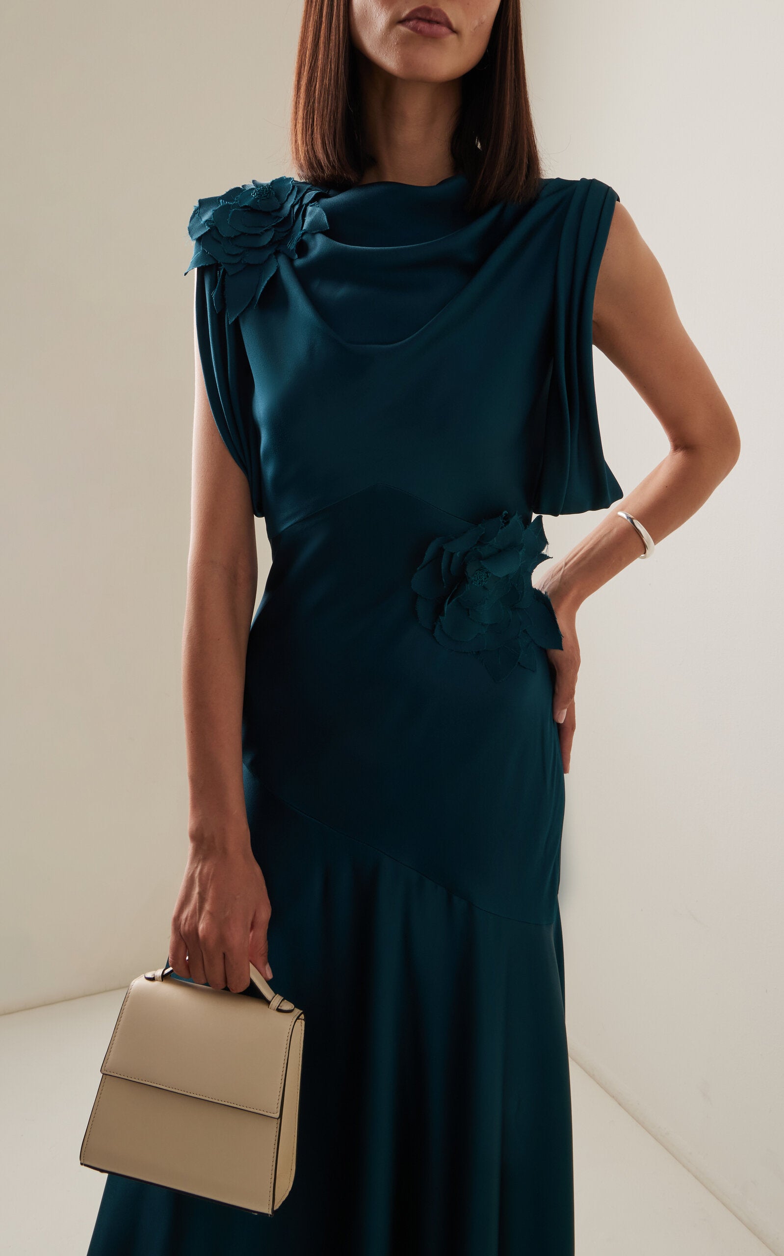 Side view of floor-length embellished A-line dress.