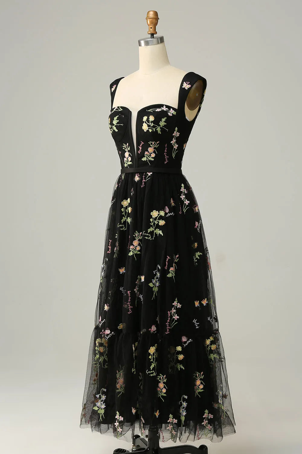 Close-up of the intricate embroidery on the dress bodice.