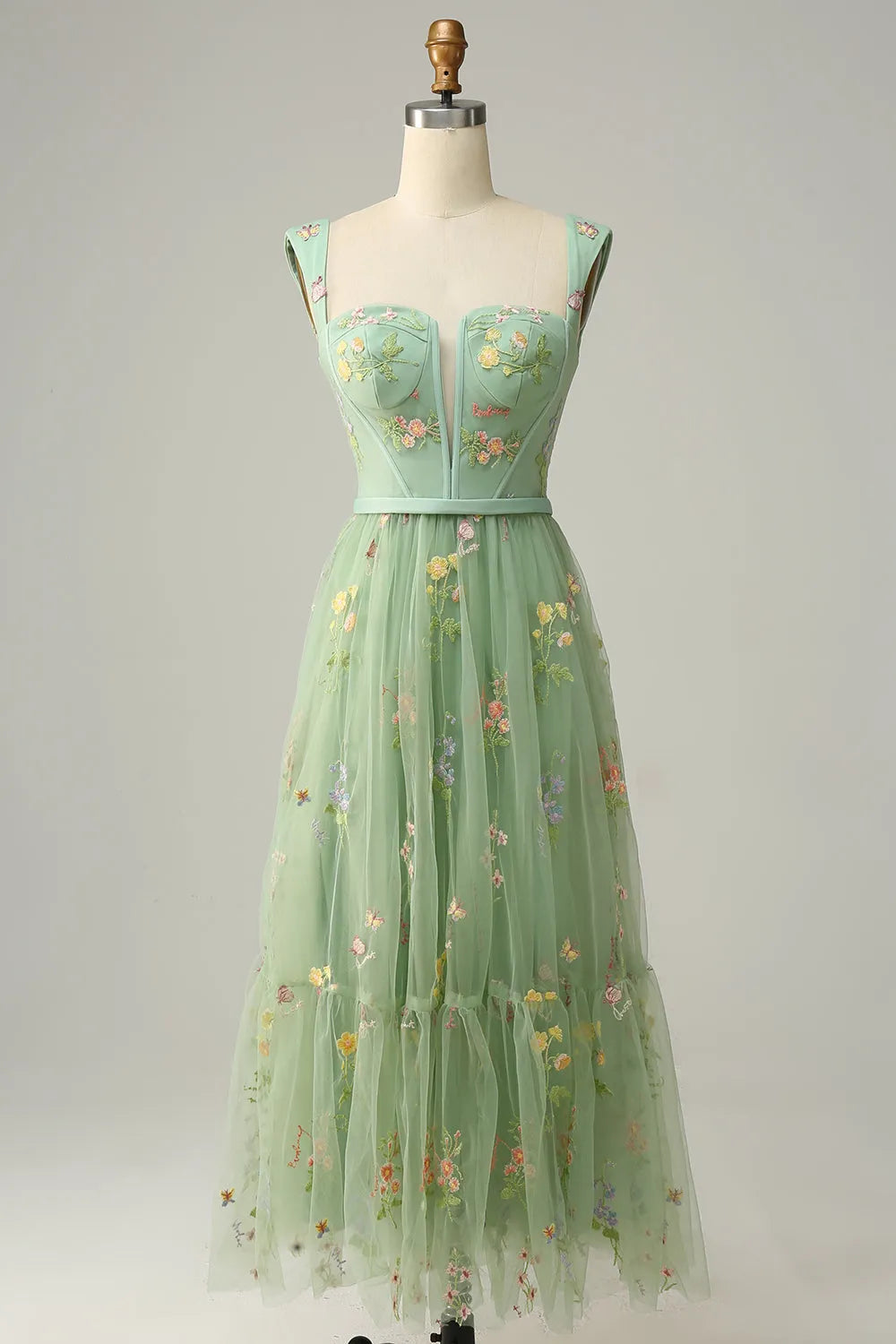 Model showcasing the back design of the embroidered prom dress.