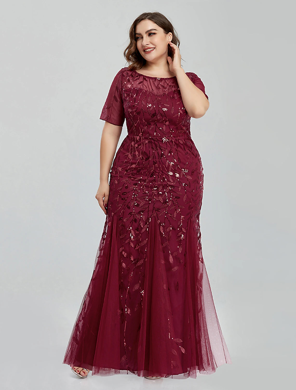 Elegant mermaid trumpet evening gown with jewel neck and short sleeves, featuring intricate tulle embroidery.
