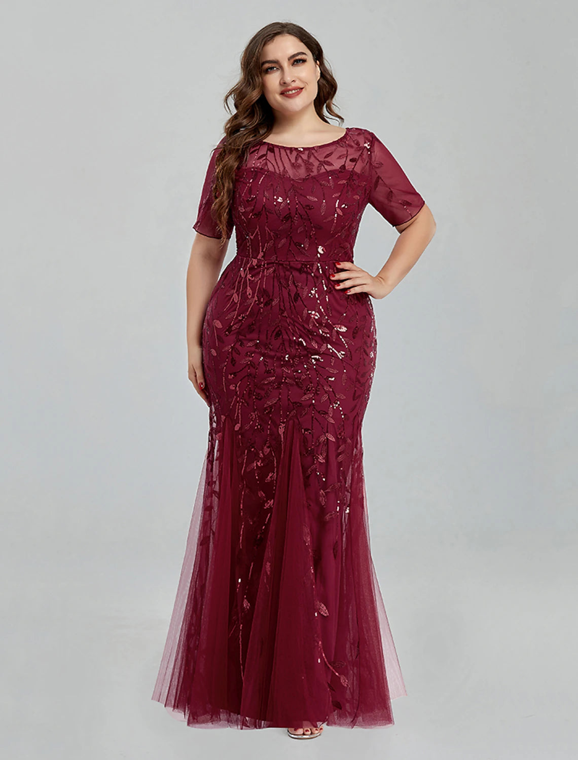 Back view of the floor-length mermaid trumpet gown, showcasing the embroidered tulle fabric.