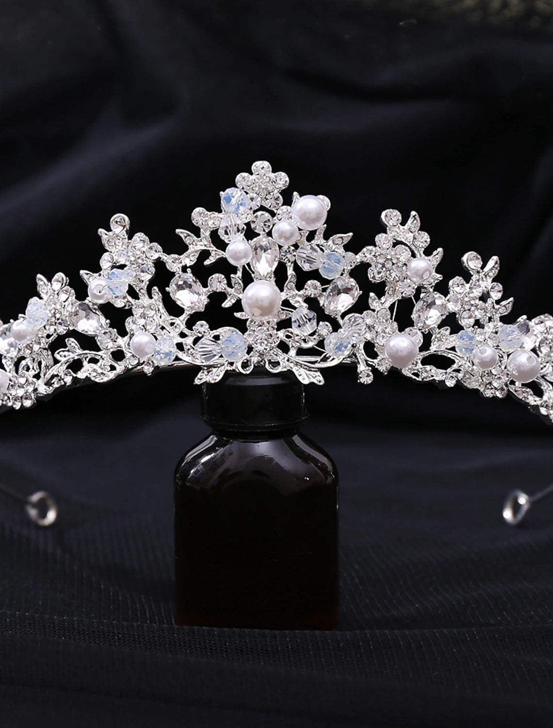 Detailed view of the intricate design of a rhinestone and pearl headband.