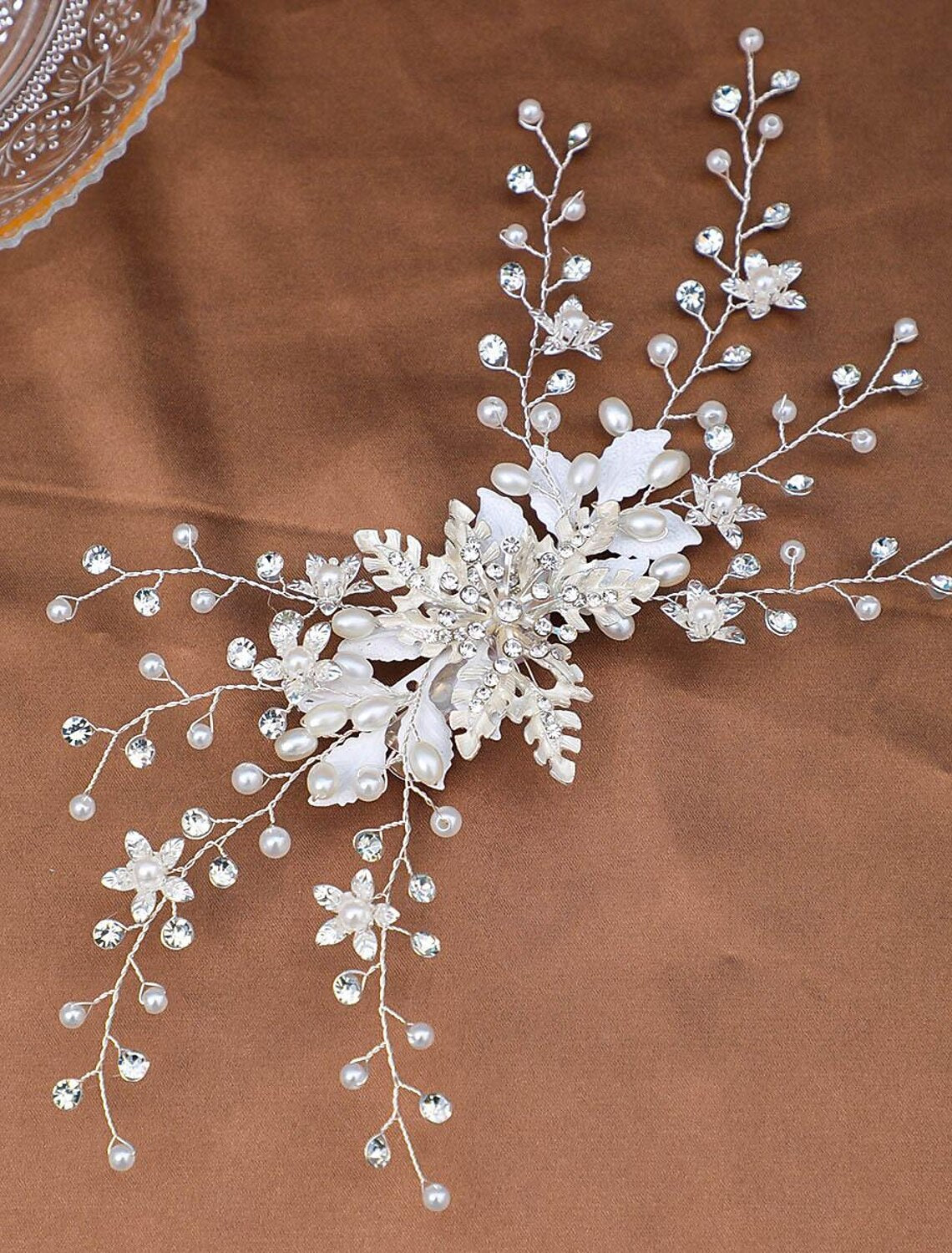 Close-up of elegant headdress clip with faux pearls and rhinestones.