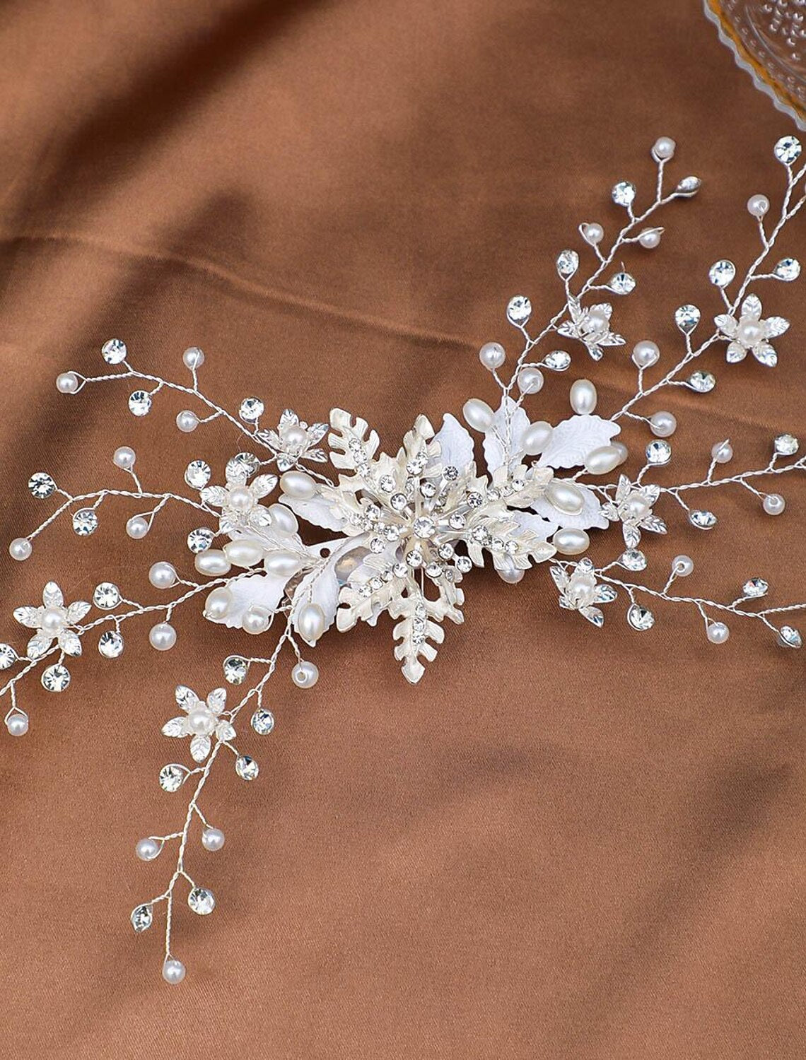 Faux pearl and rhinestone bridal headpiece on display.