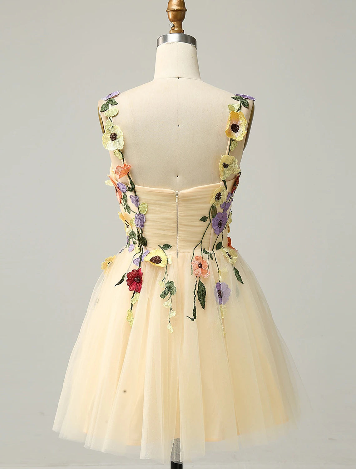 Back view of the short tulle A-line dress with floral appliques.