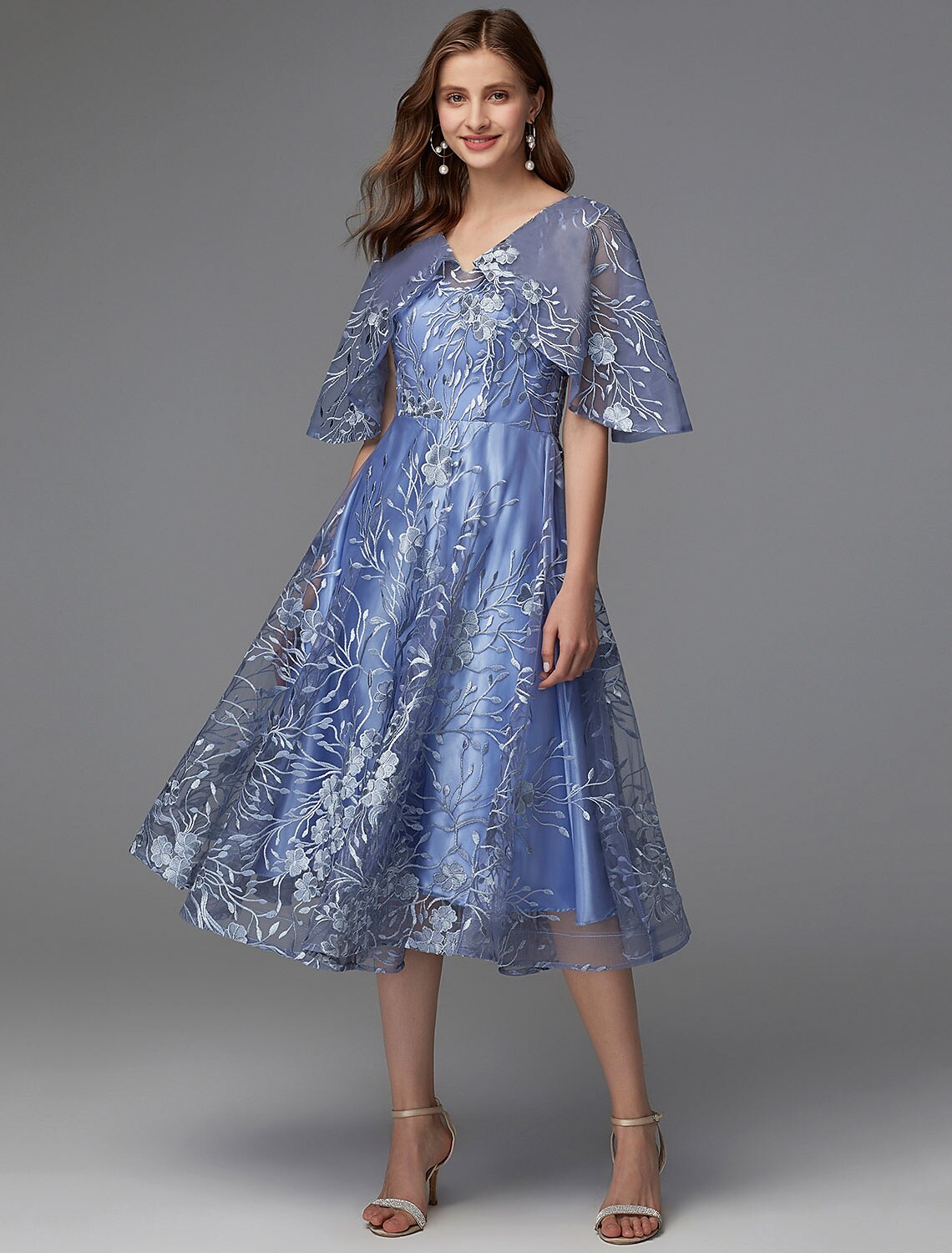 Back view of a woman in a floral A-line dress showing V-back detail.