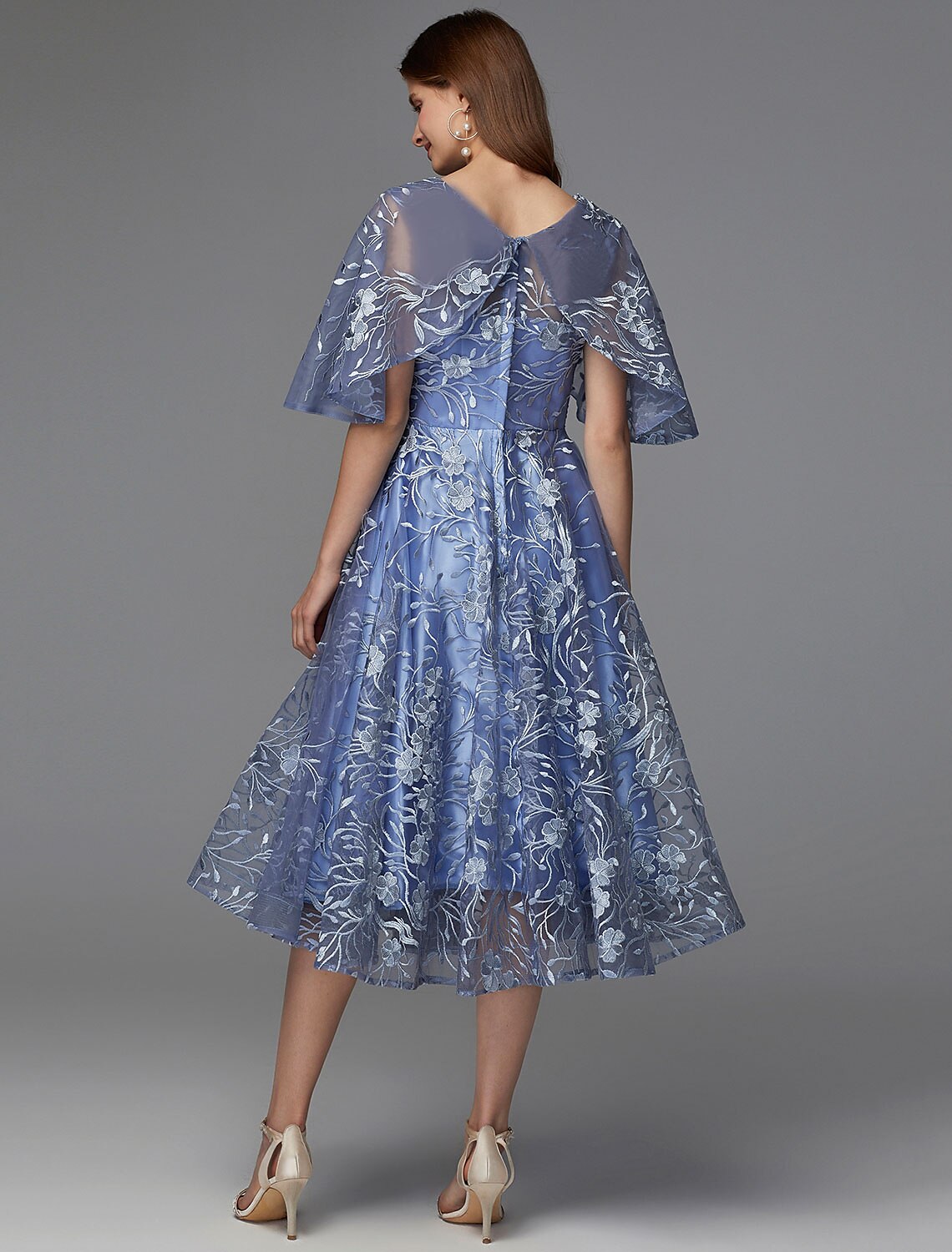 Close-up of the lace and applique details on the floral A-line dress.
