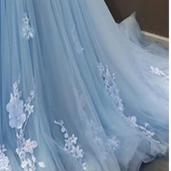 Close-up of lace appliques and pleats on the floral ball gown.