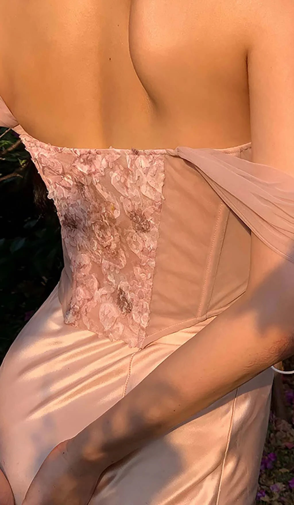 Back view of the floral embroidered prom dress featuring a lace-up corset.