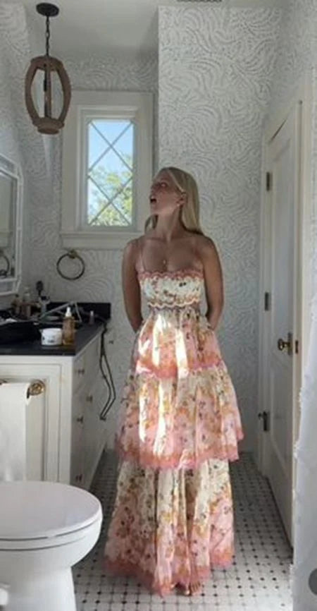 Model wearing a Laurel Blossom floral print V-neck tiered midi dress.