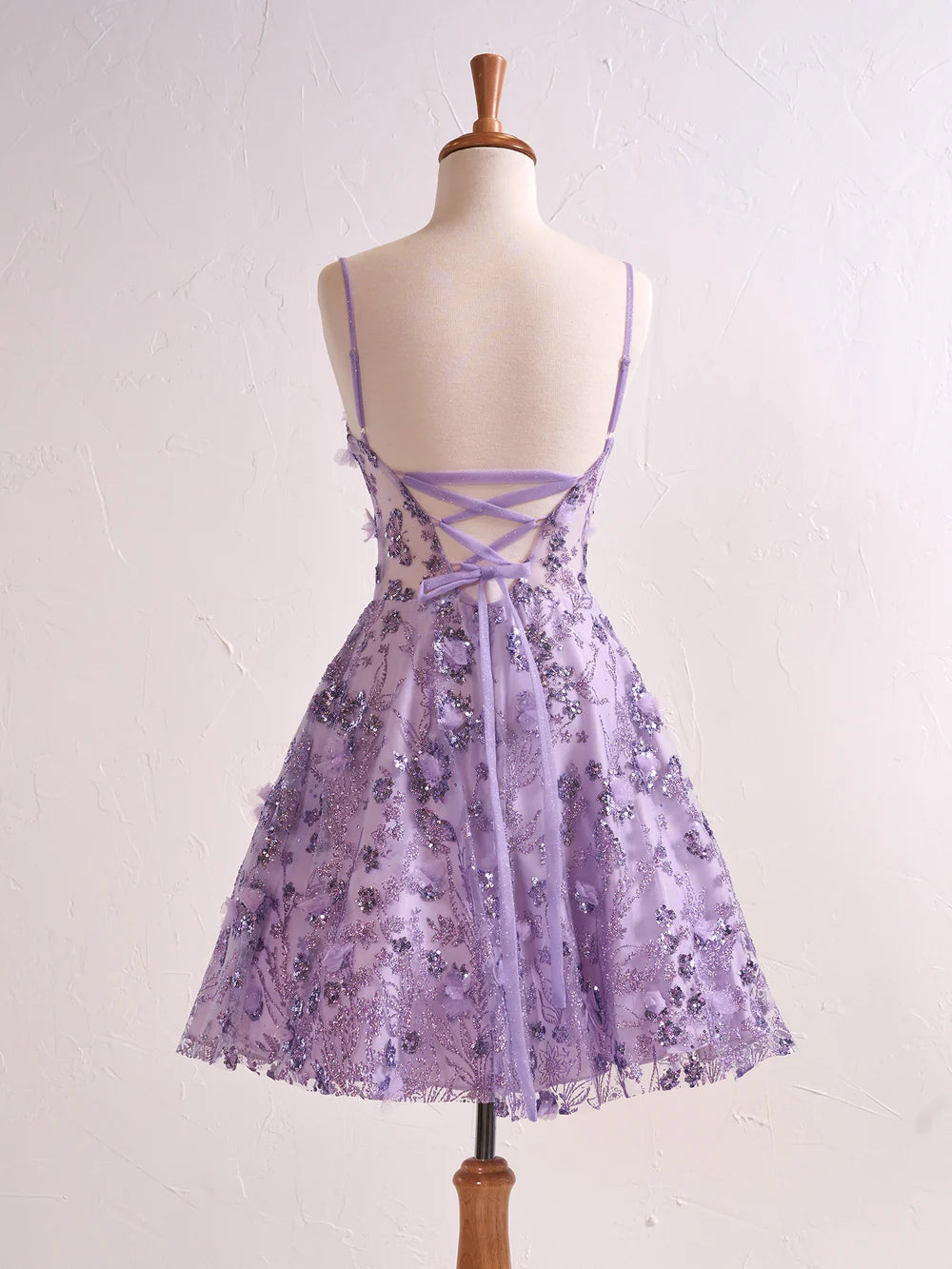 Side view of a model in a floral strapless sweetheart cocktail dress.