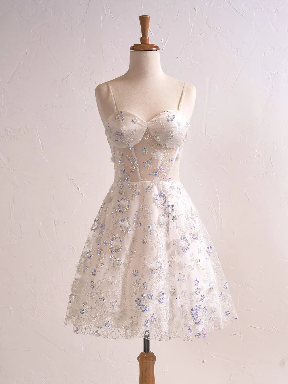 Back view of a floral strapless sweetheart short cocktail dress.