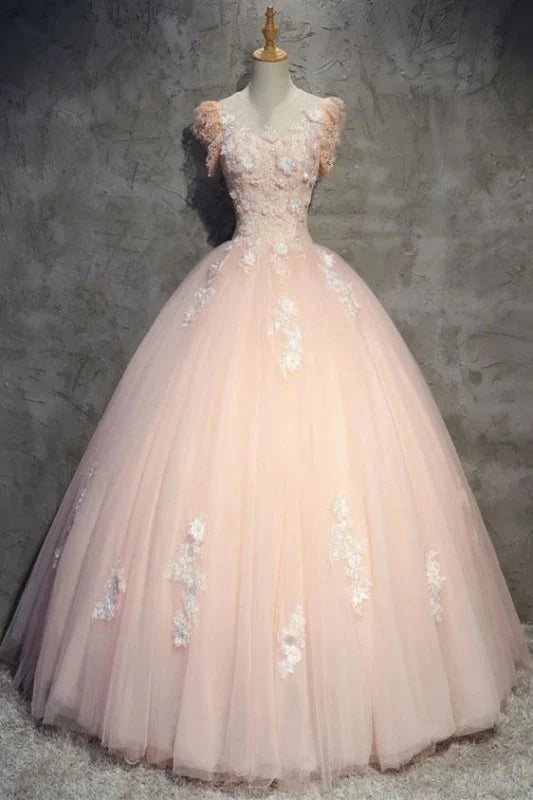 Woman wearing an elegant floral tulle ball gown with a sheer neckline.