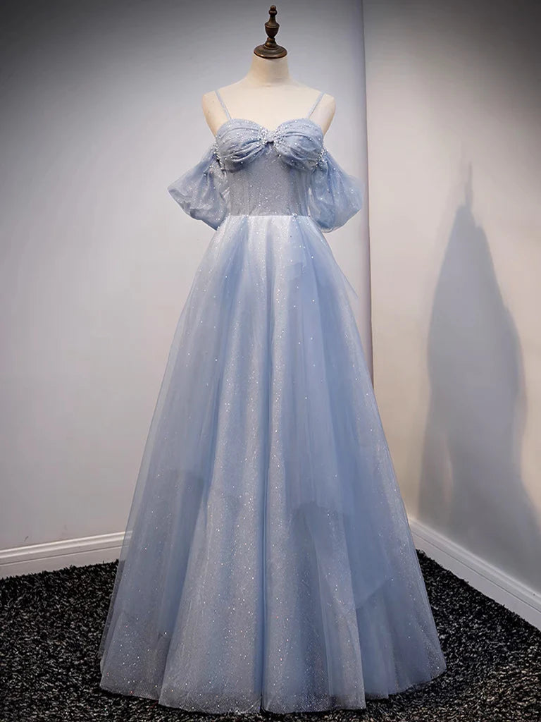 Woman in light blue A-line off-shoulder tulle prom dress.