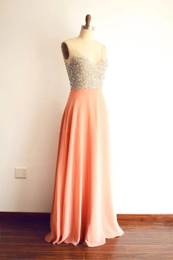 Model wearing an elegant long sweetheart chiffon prom gown with crystal beading.
