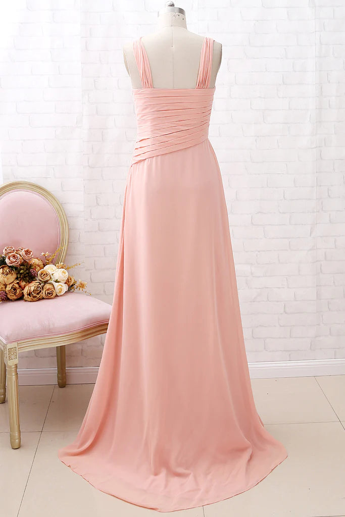 Side view of a woman in a coral long chiffon formal dress.