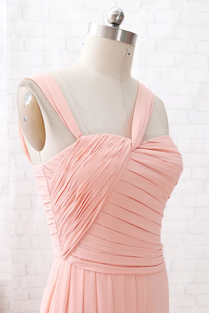 Back view of a woman in an elegant coral chiffon wedding party dress.