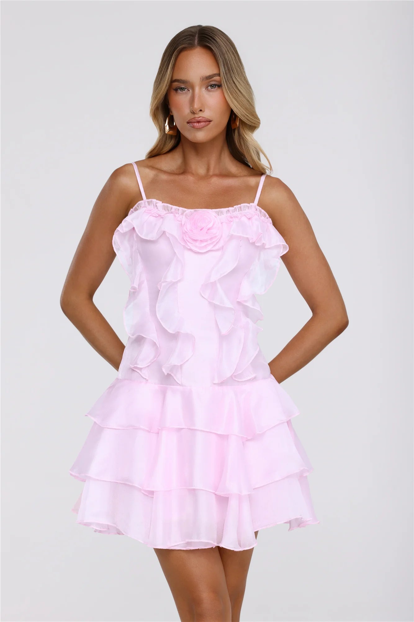 Model wearing elegant pink spaghetti strap homecoming dress.