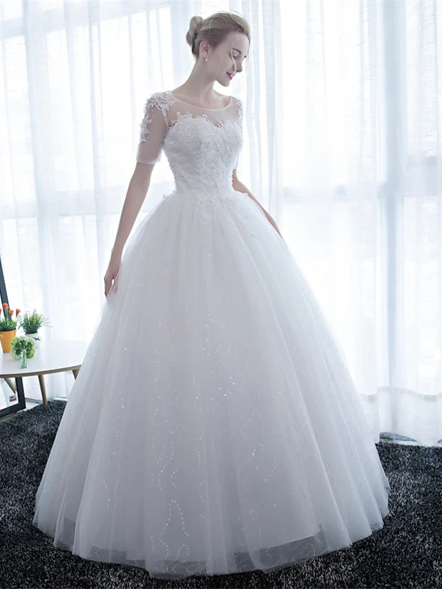 Full length view of the elegant satin and lace wedding gown.