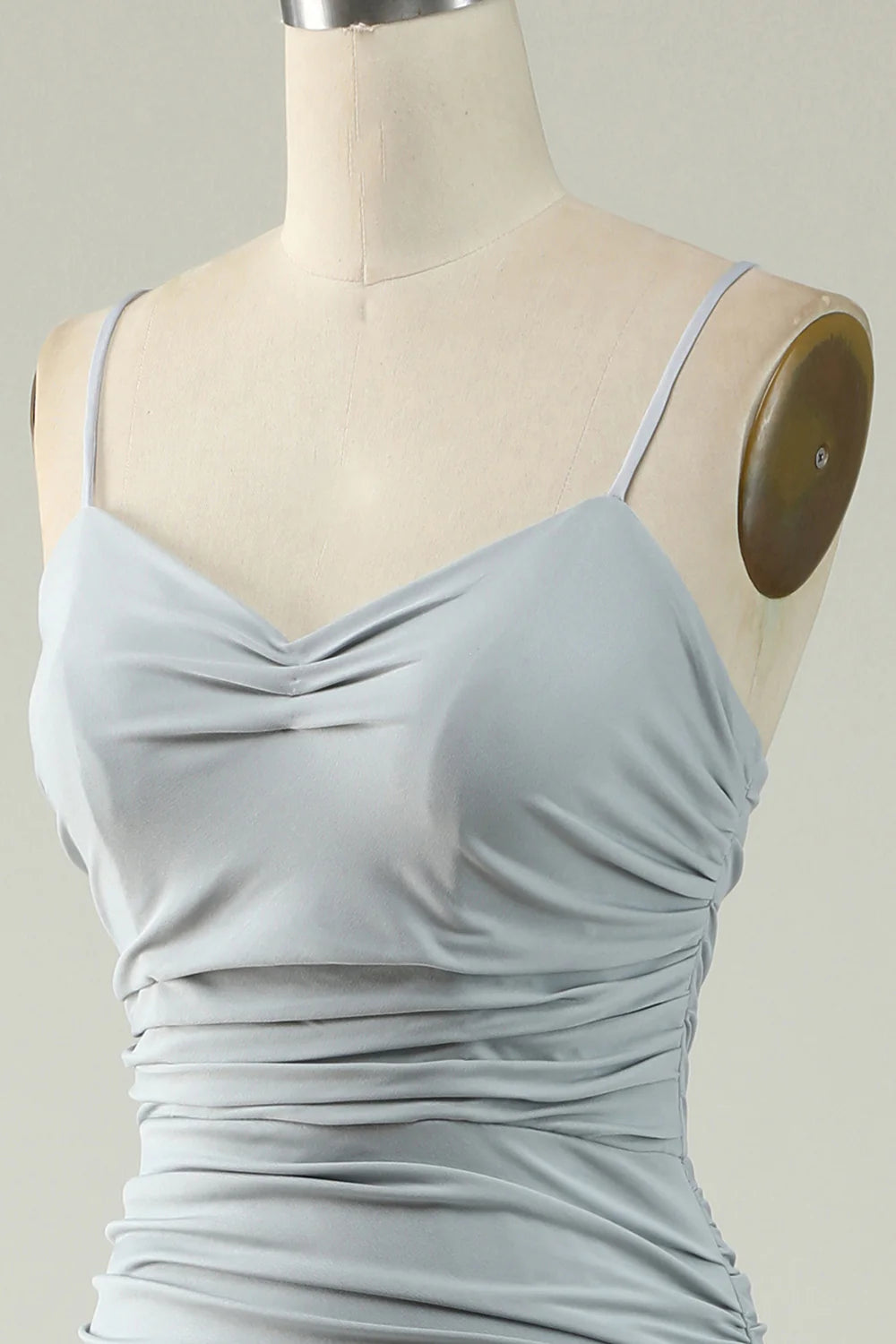 Woman in a grey mermaid prom dress, highlighting the V-neckline and fitted bodice.