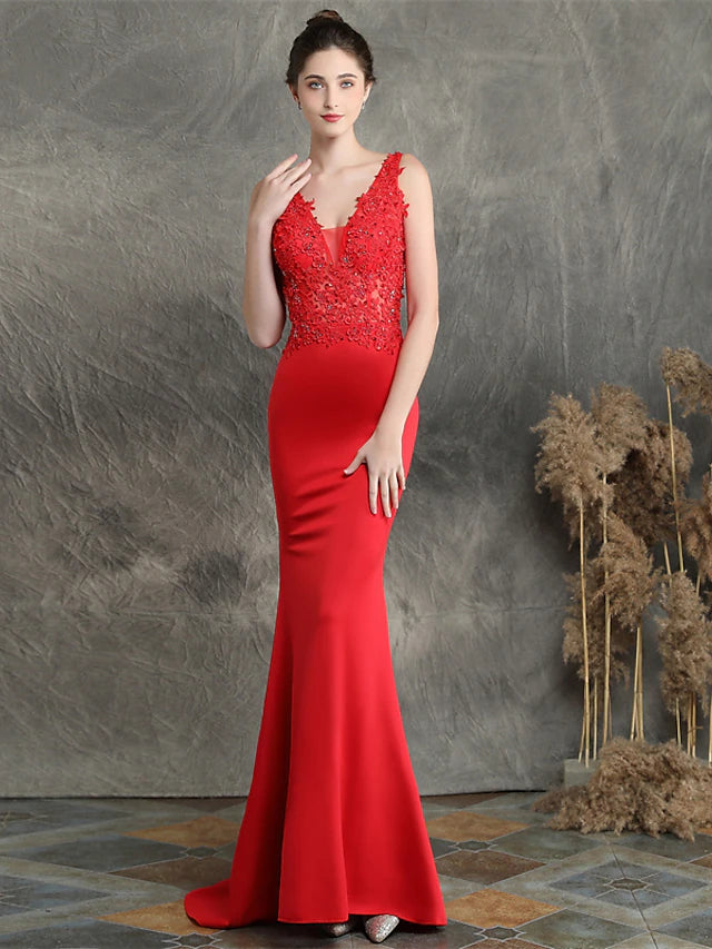 Elegant V-neck Mermaid Trumpet evening gown with intricate beading and appliques, featuring a sweep train.