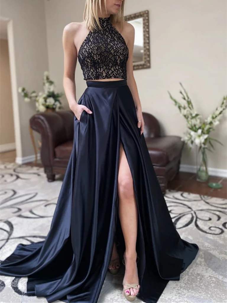 Woman wearing an elegant two-piece high neck sleeveless long prom dress with a side slit.