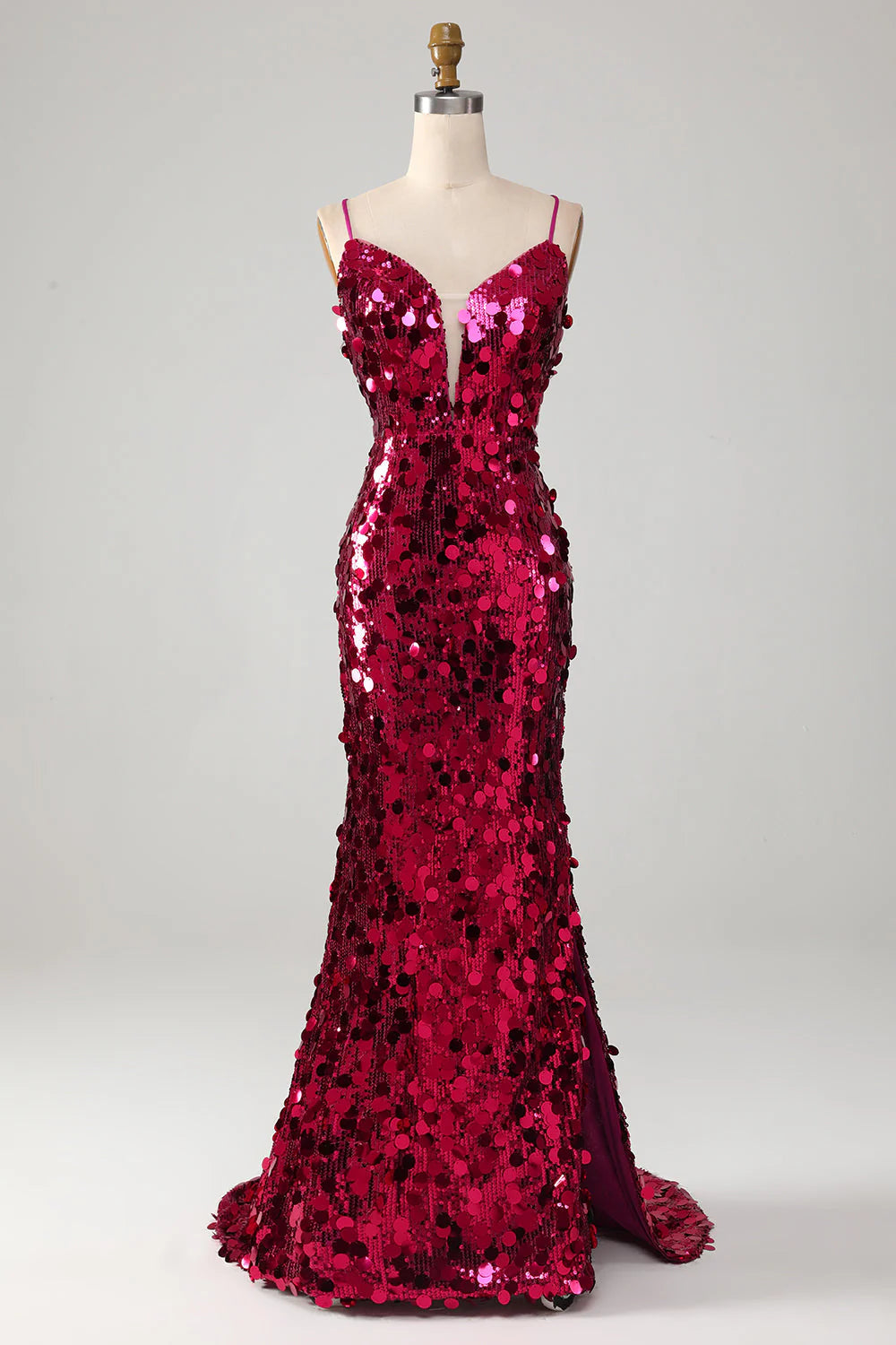Fuchsia sequin mermaid prom dress with spaghetti straps and a high slit, front view.