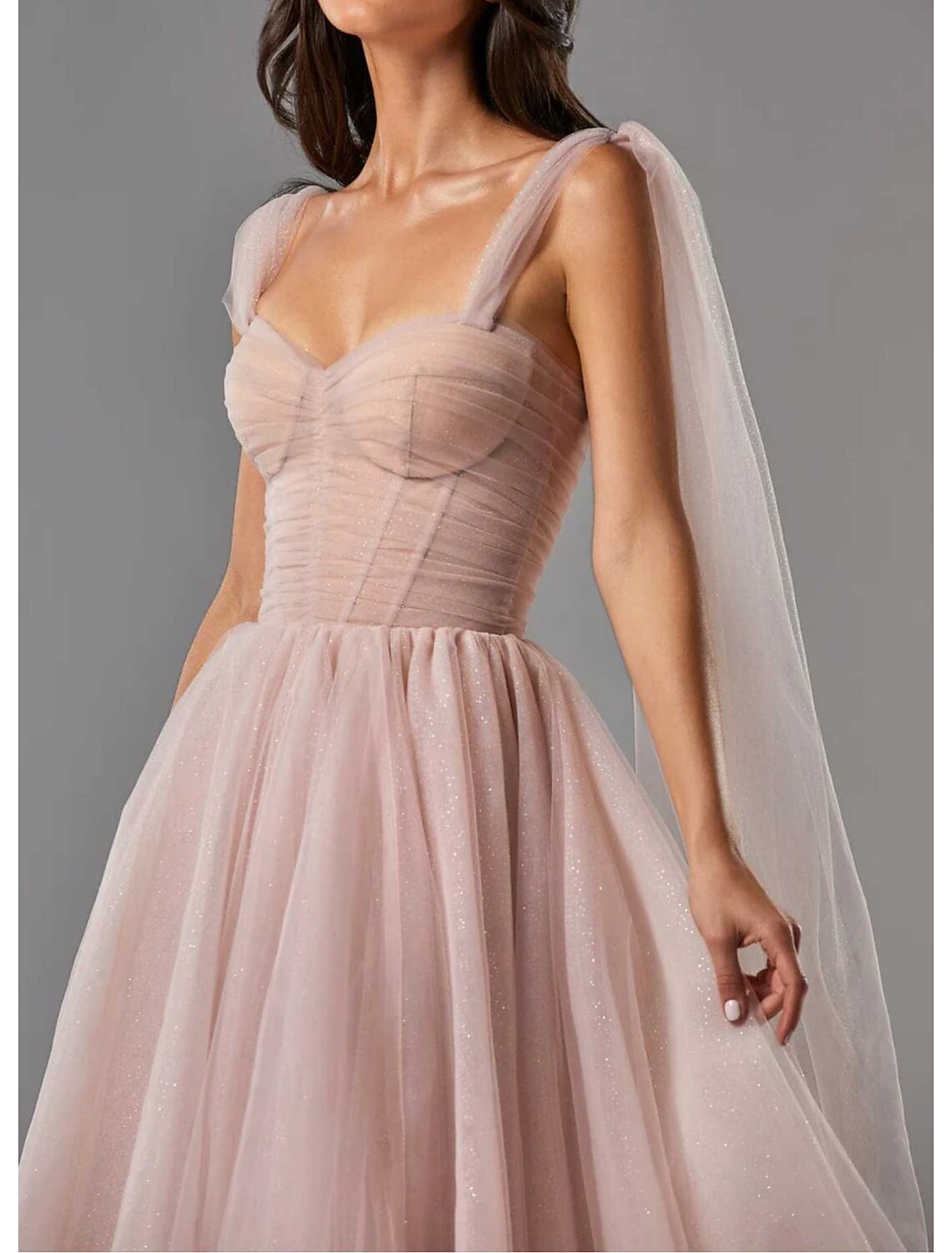 Back view of the sleeveless square neck dress, showing the flowing tulle skirt.