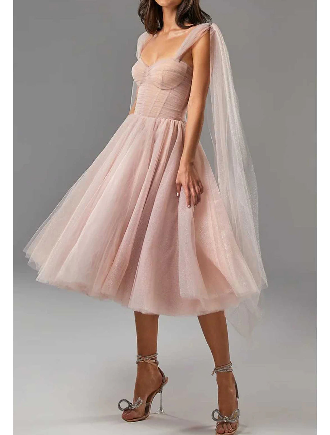 Close-up of the shimmering glitter tulle fabric and square neckline on the ball gown.
