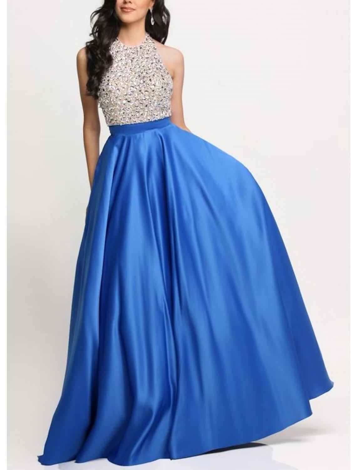 Woman wearing an elegant A-Line halter neck evening gown with glitter satin fabric.