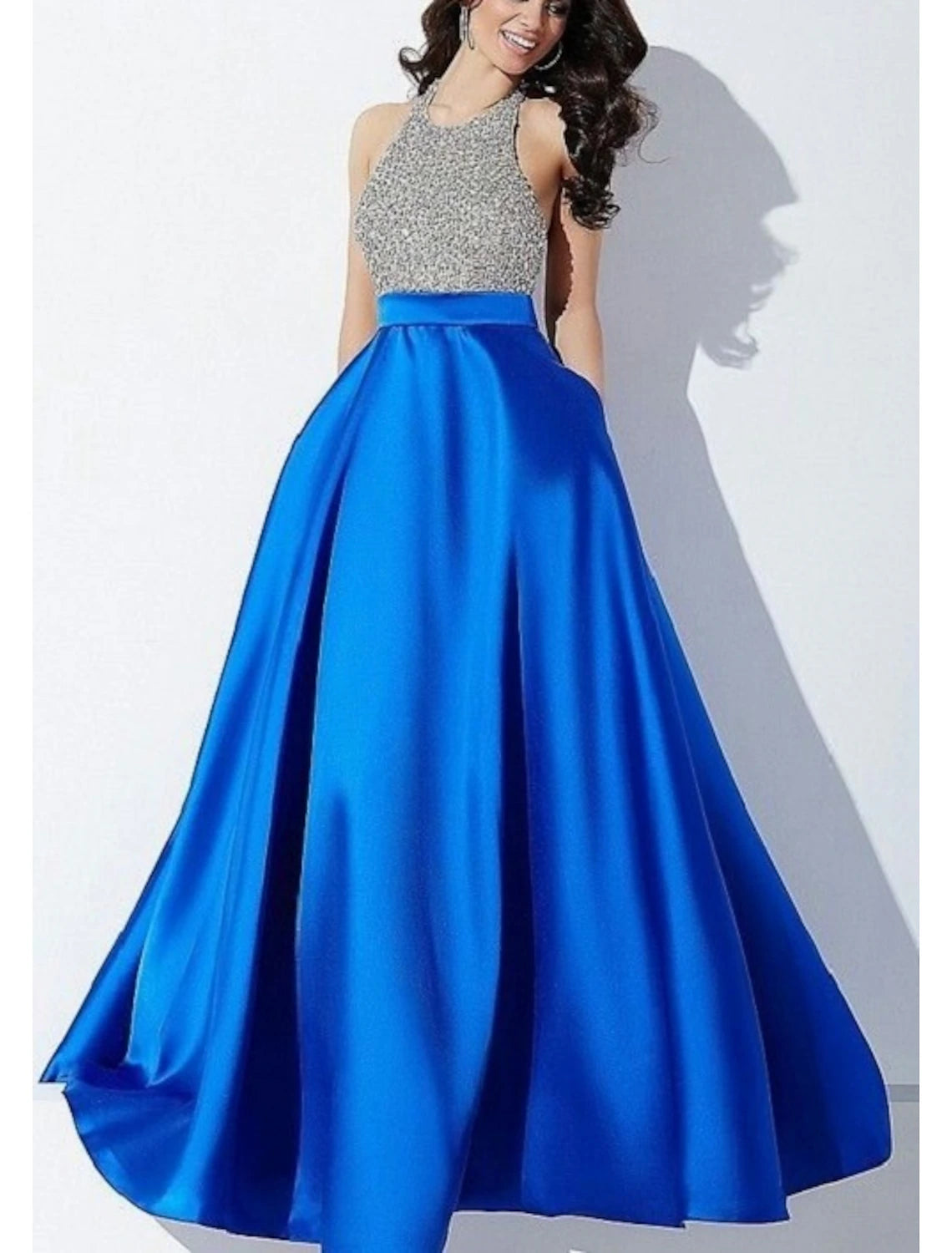 Full view of the floor-length sleeveless formal dress with a shimmering finish.