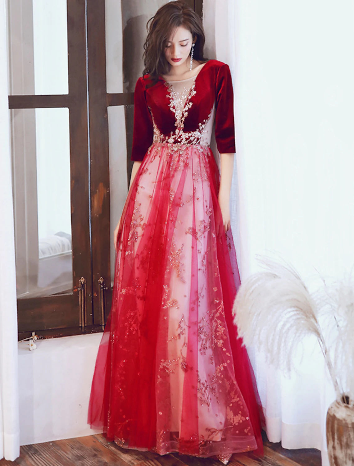 Back view of a glittering floor-length formal dress with sequin appliques.
