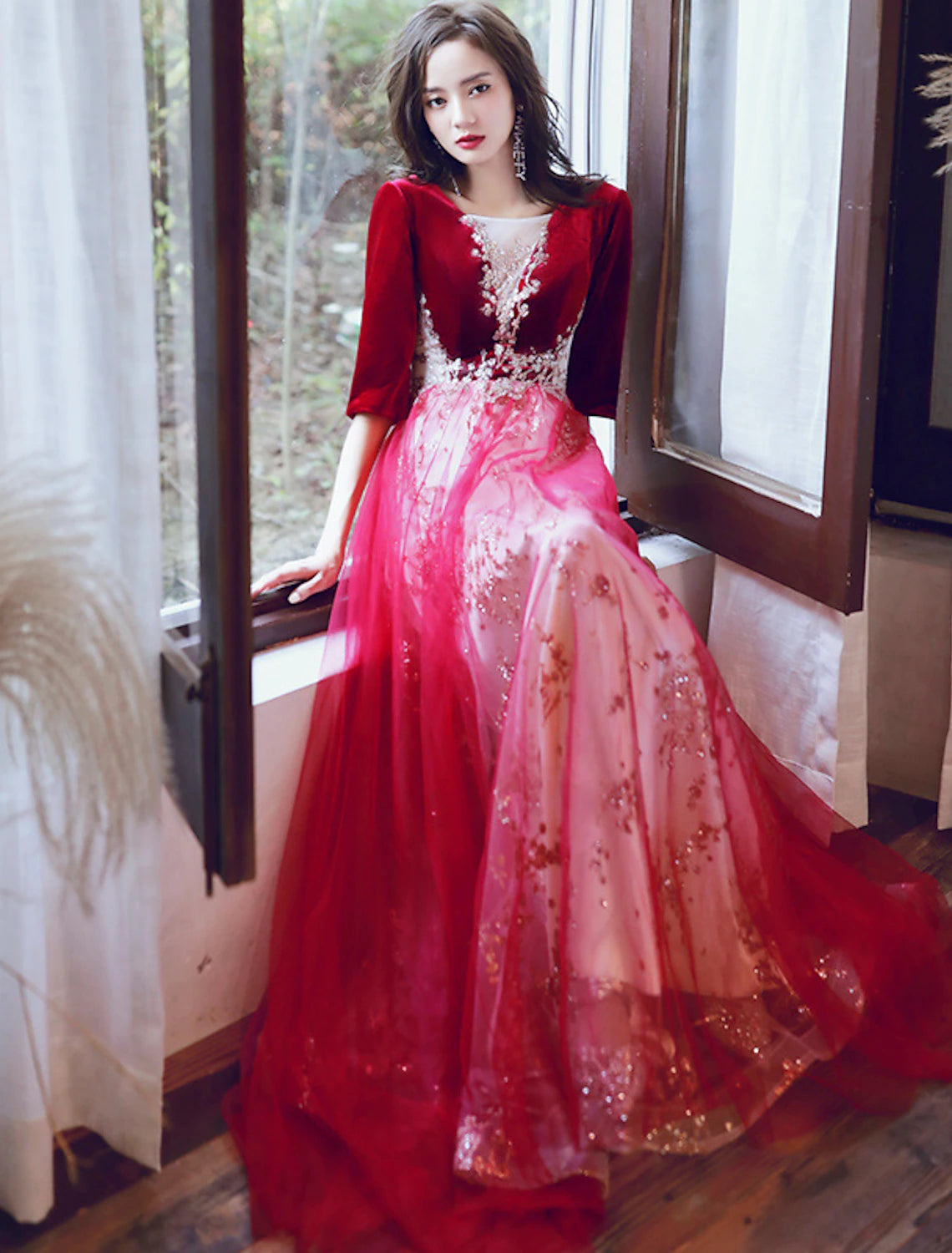 Full length view of a woman in a glittering A-line formal gown.