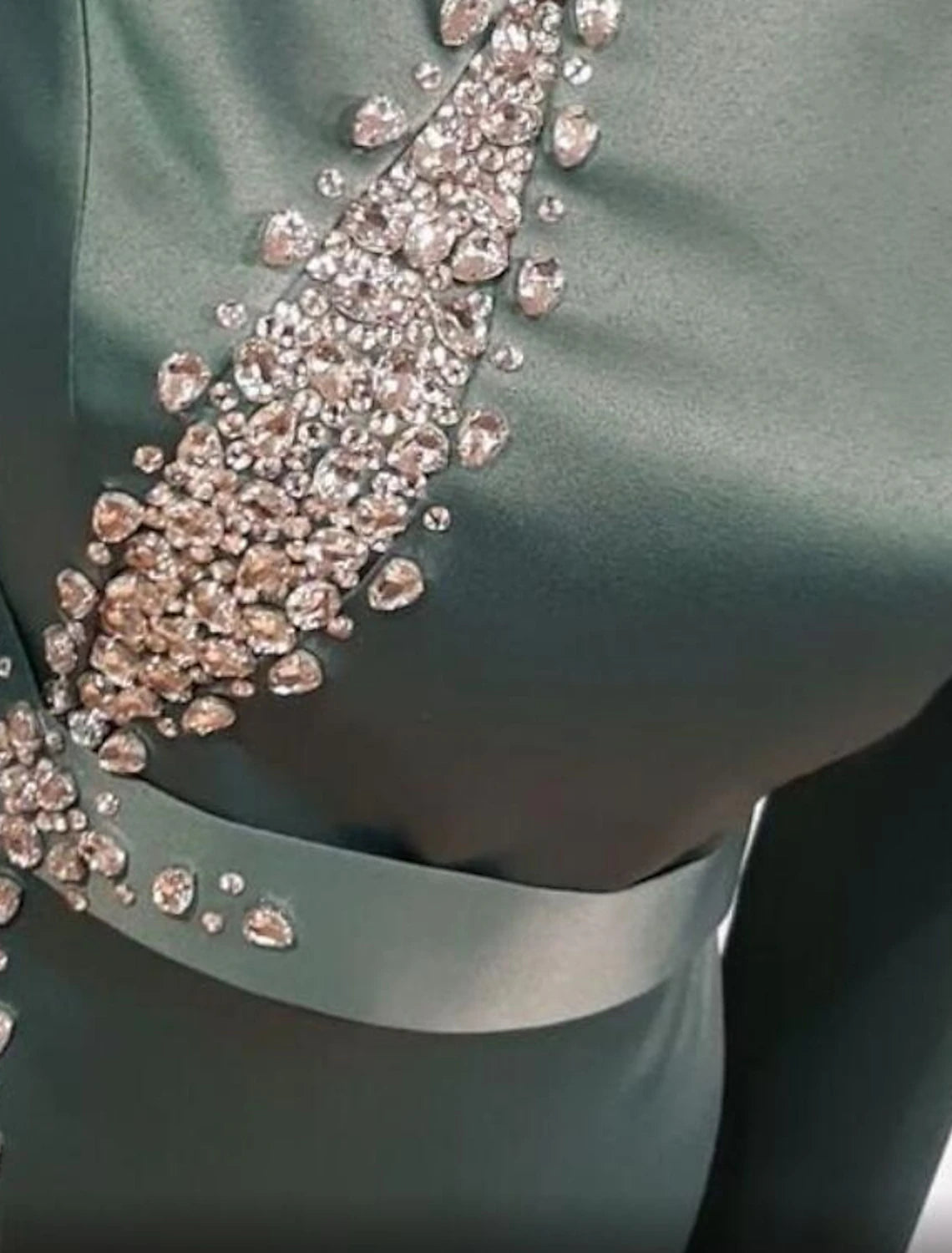 Back view of the long sleeve evening gown with intricate beading and sequins.
