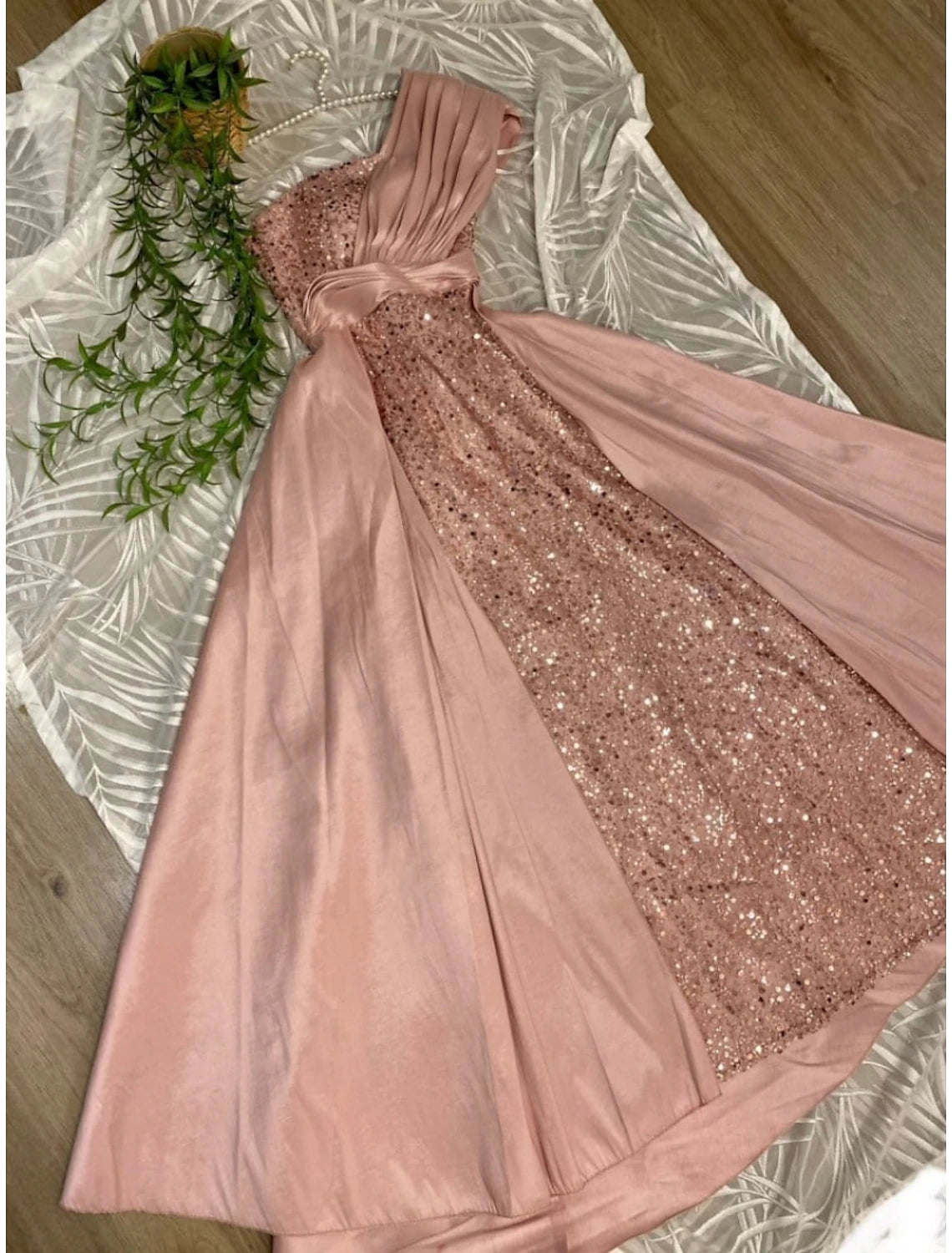 Elegant one-shoulder sheath evening gown with glittering sequins and ruched satin.