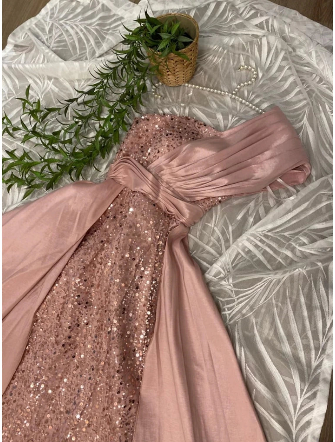 Full-length view of the glittering one-shoulder formal dress.
