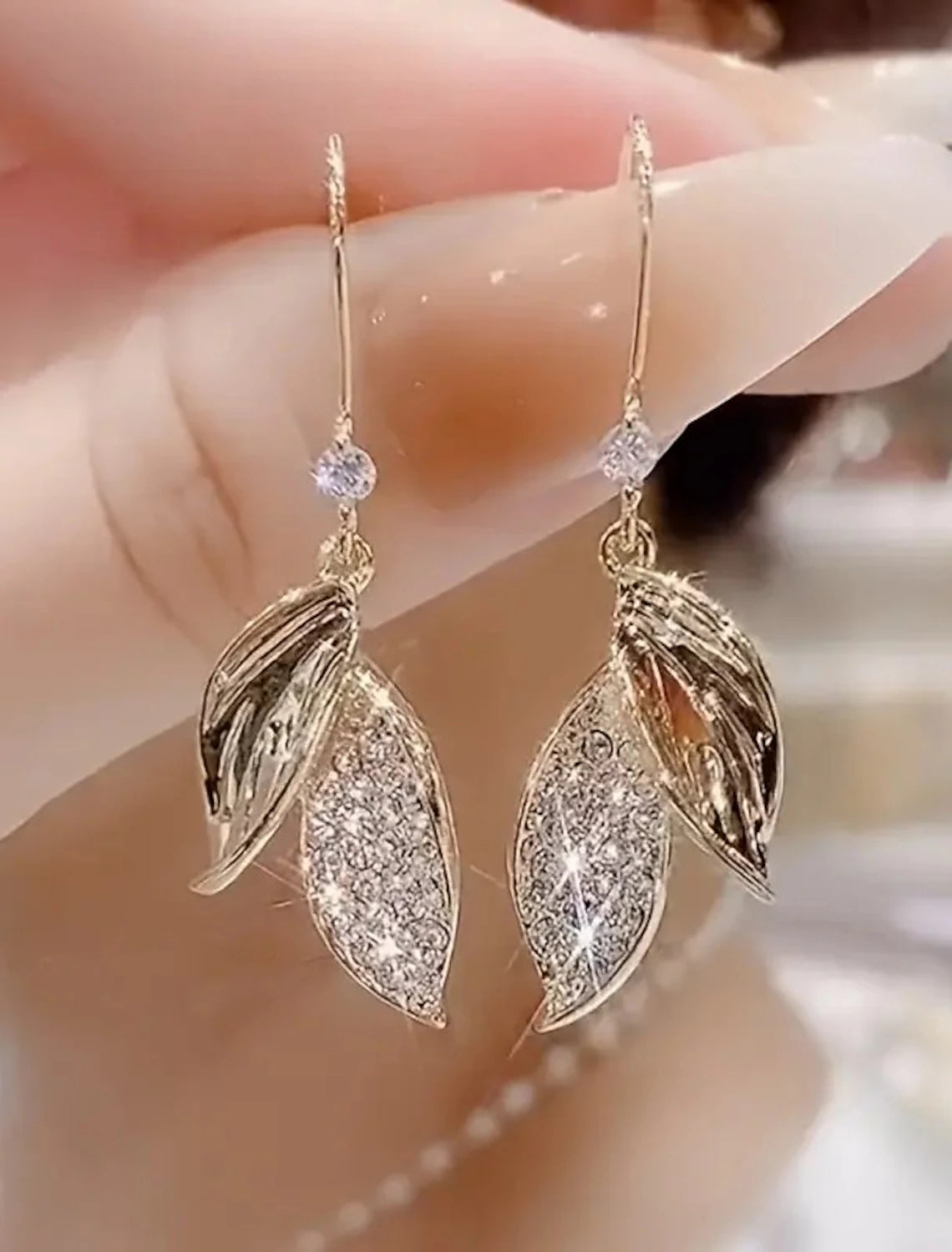 Elegant gold leaf drop earring, front view.