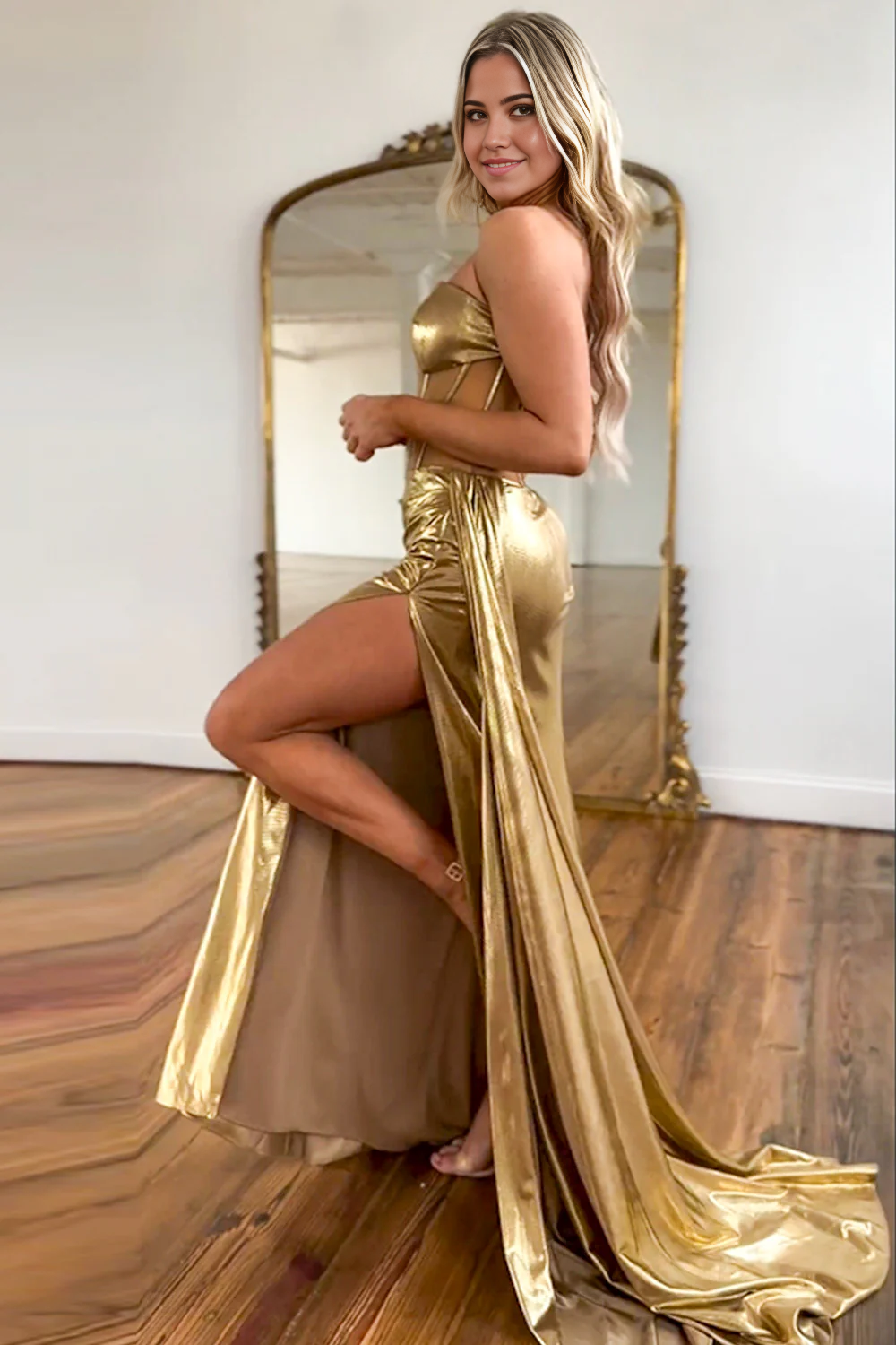 Gold mermaid strapless formal dress with a high slit, side view.