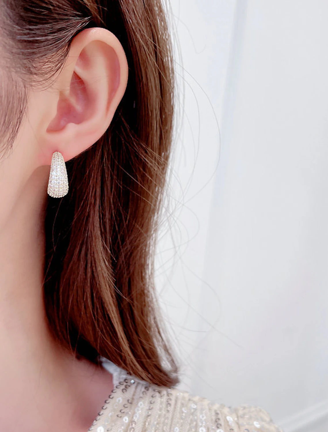 Gold zircon hoop earring showcasing its stylish drop.