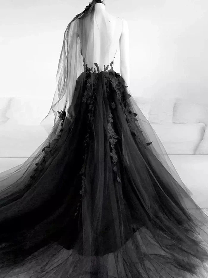 Close-up of the intricate lace details and backless design on a gothic wedding dress.