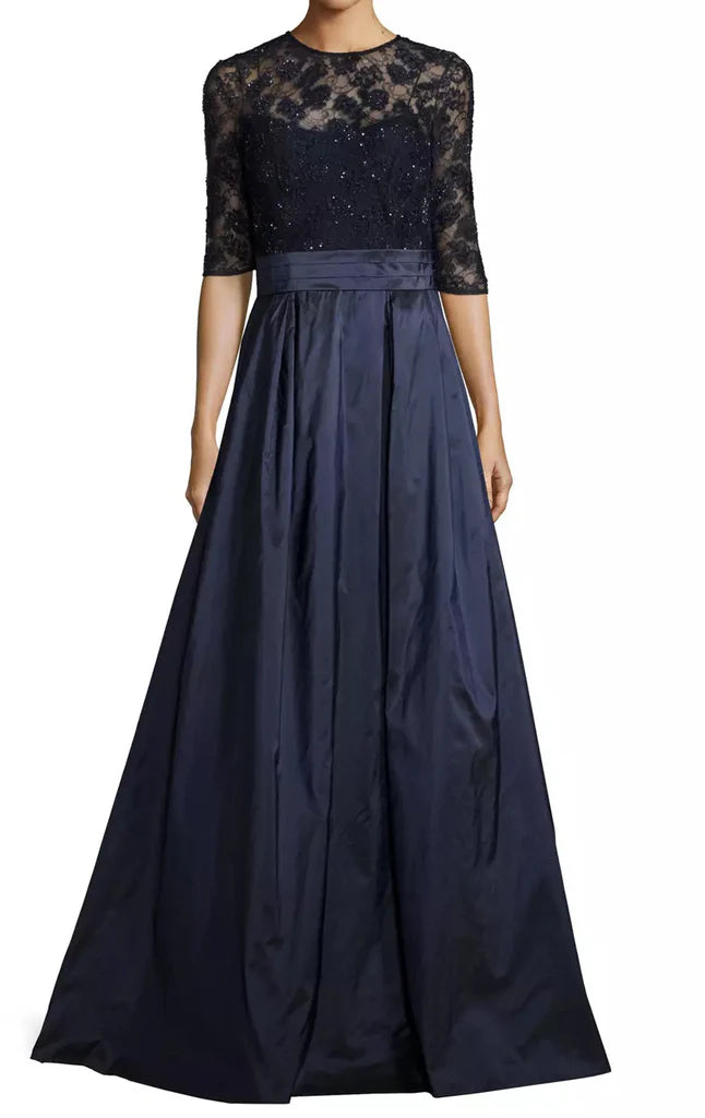 Woman wearing an elegant long lace Mother of the Bride dress with half sleeves.