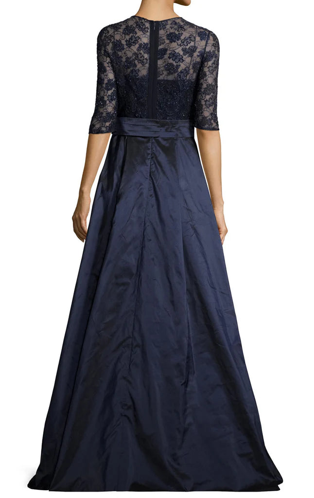 Back view of a woman in a long lace Mother of the Bride dress with half sleeves.