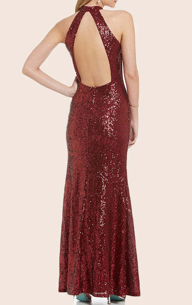 Back view of a woman in a sequin halter maxi dress, highlighting the open back design.