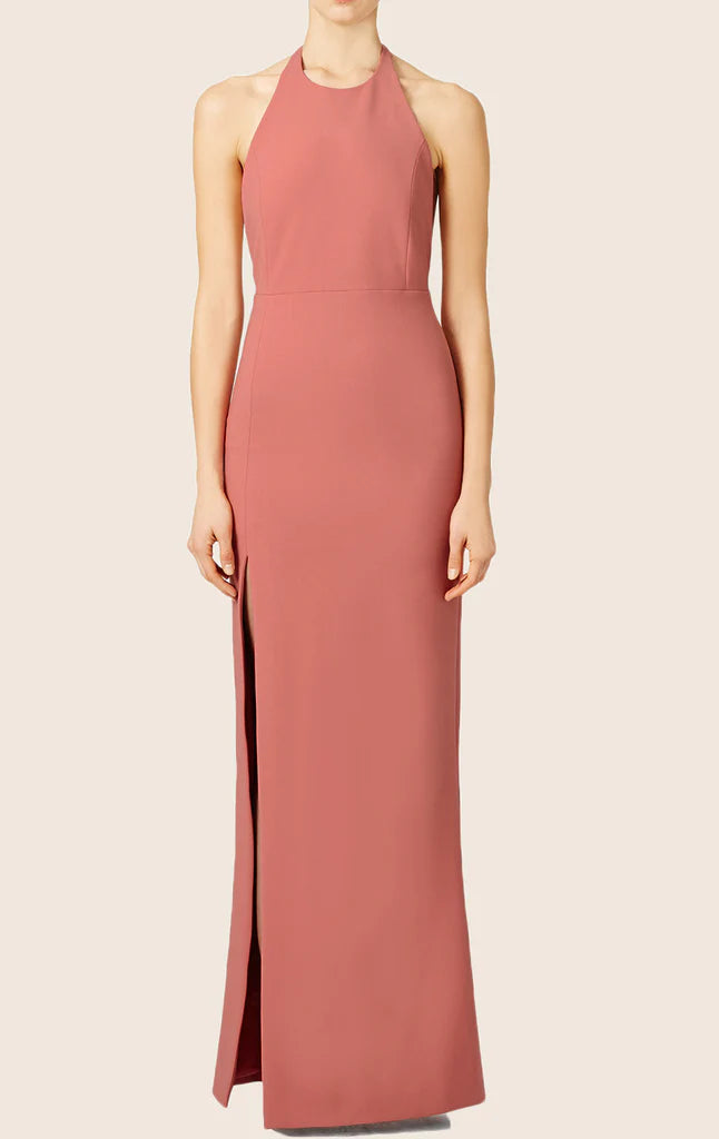 Woman wearing an elegant halter formal evening gown with a high slit.